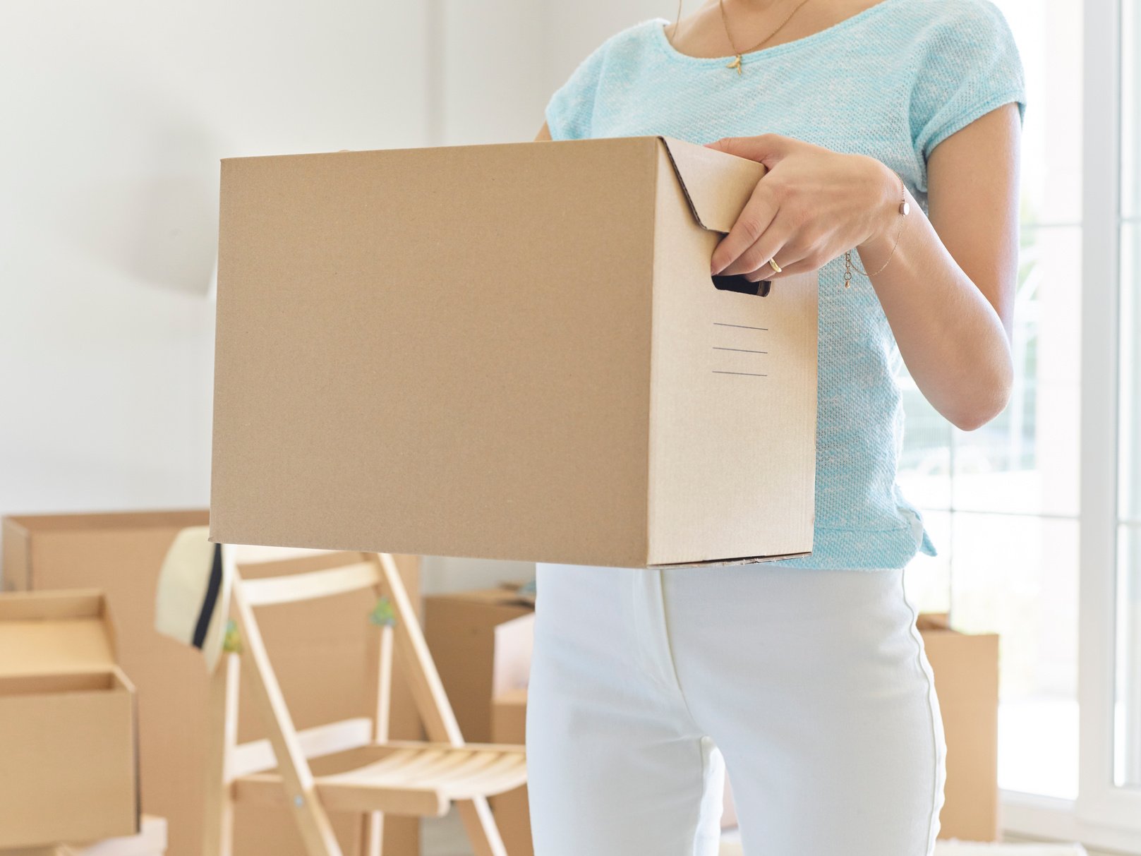 Woman carrying cardboard box